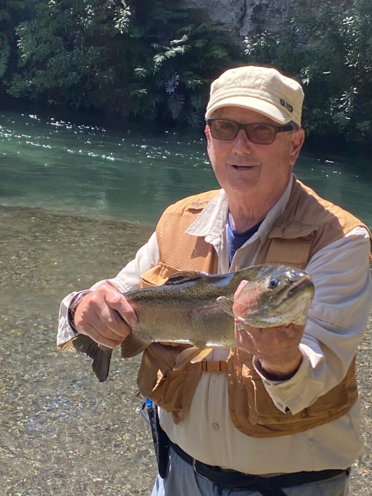 Mike Webster holding a fish caught with the Taupo Fishing club